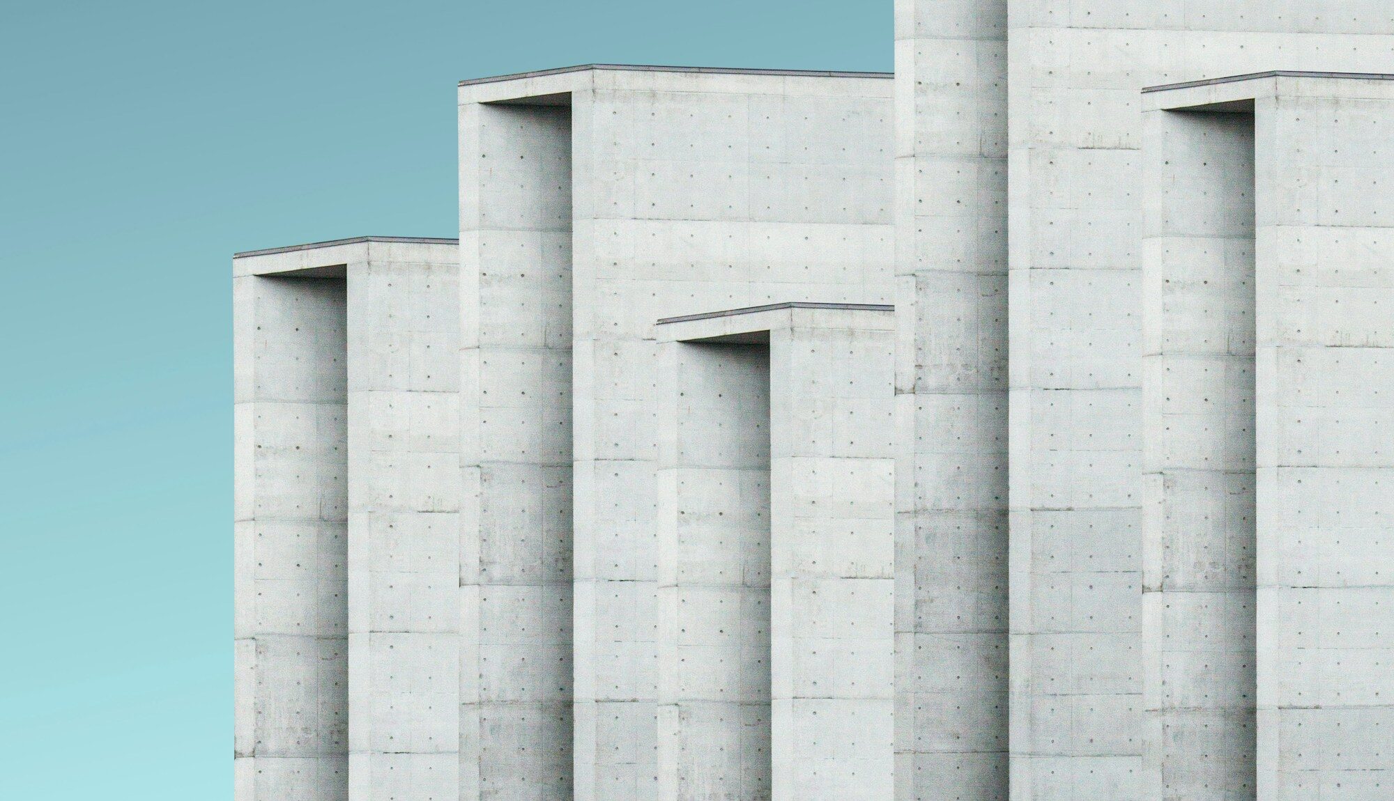 A sculptural concrete building against a clear sky