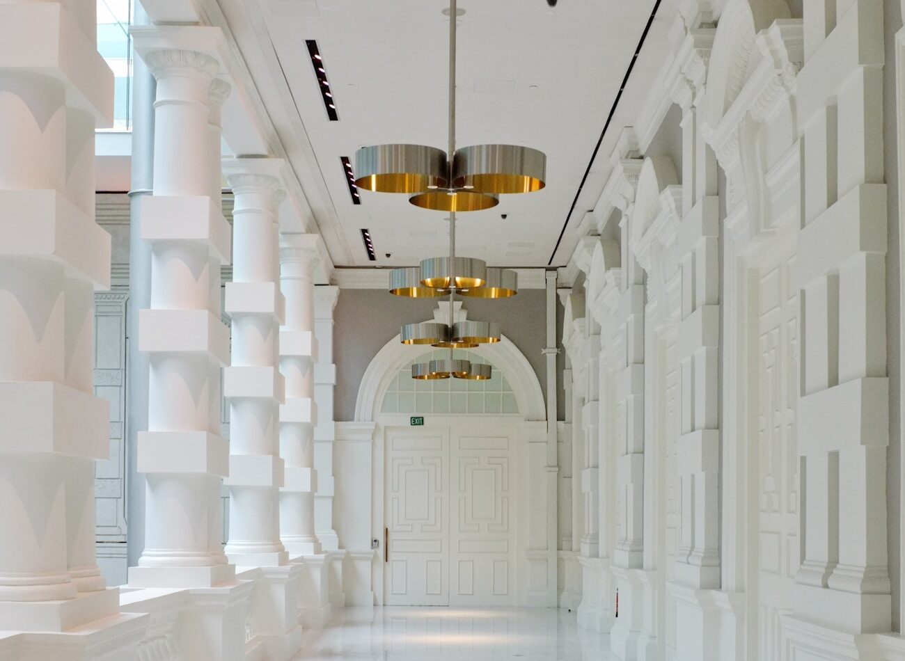 A white vaulted gallery lit from above
