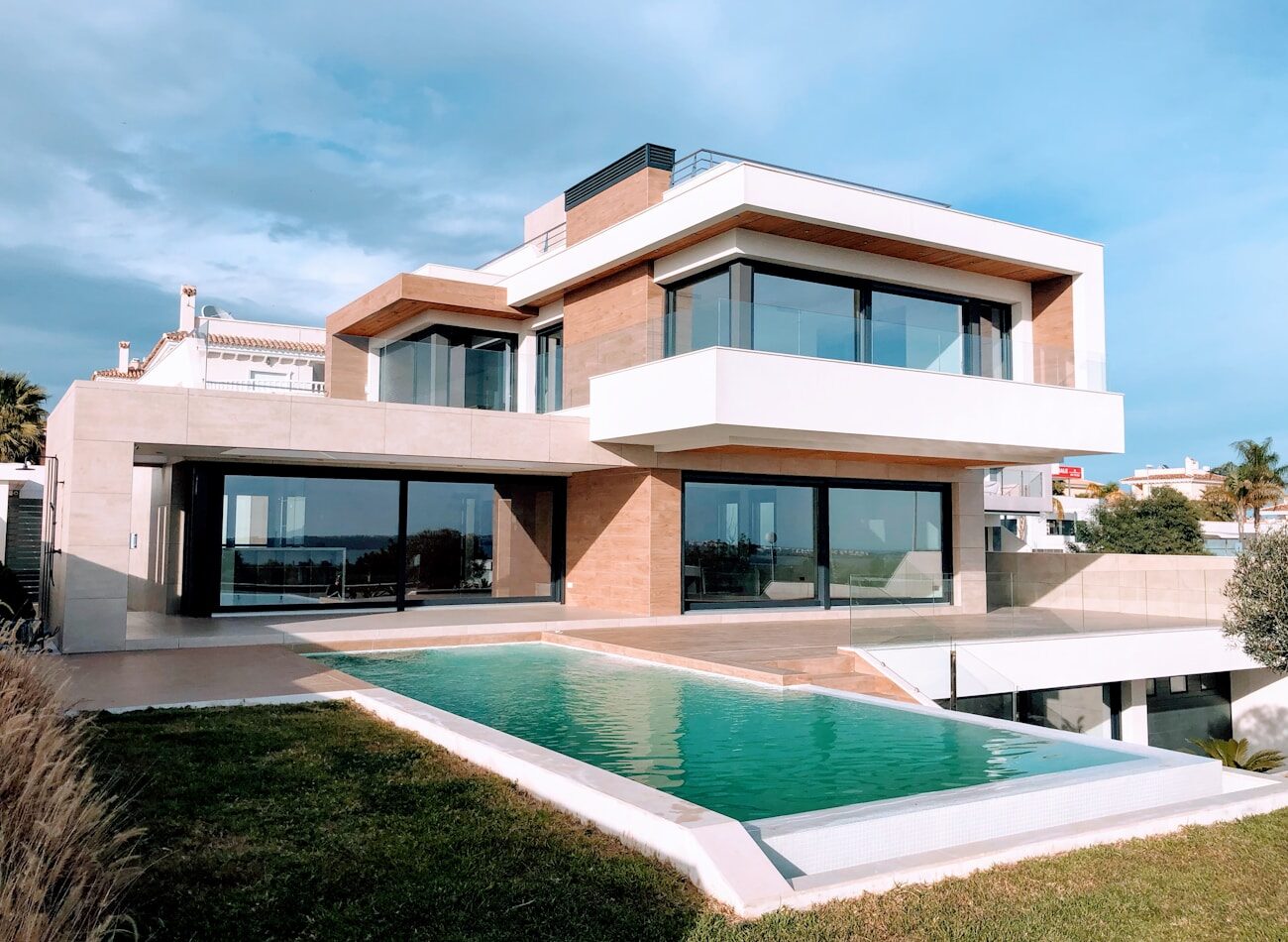 A low villa stepping down a hillside above a pool