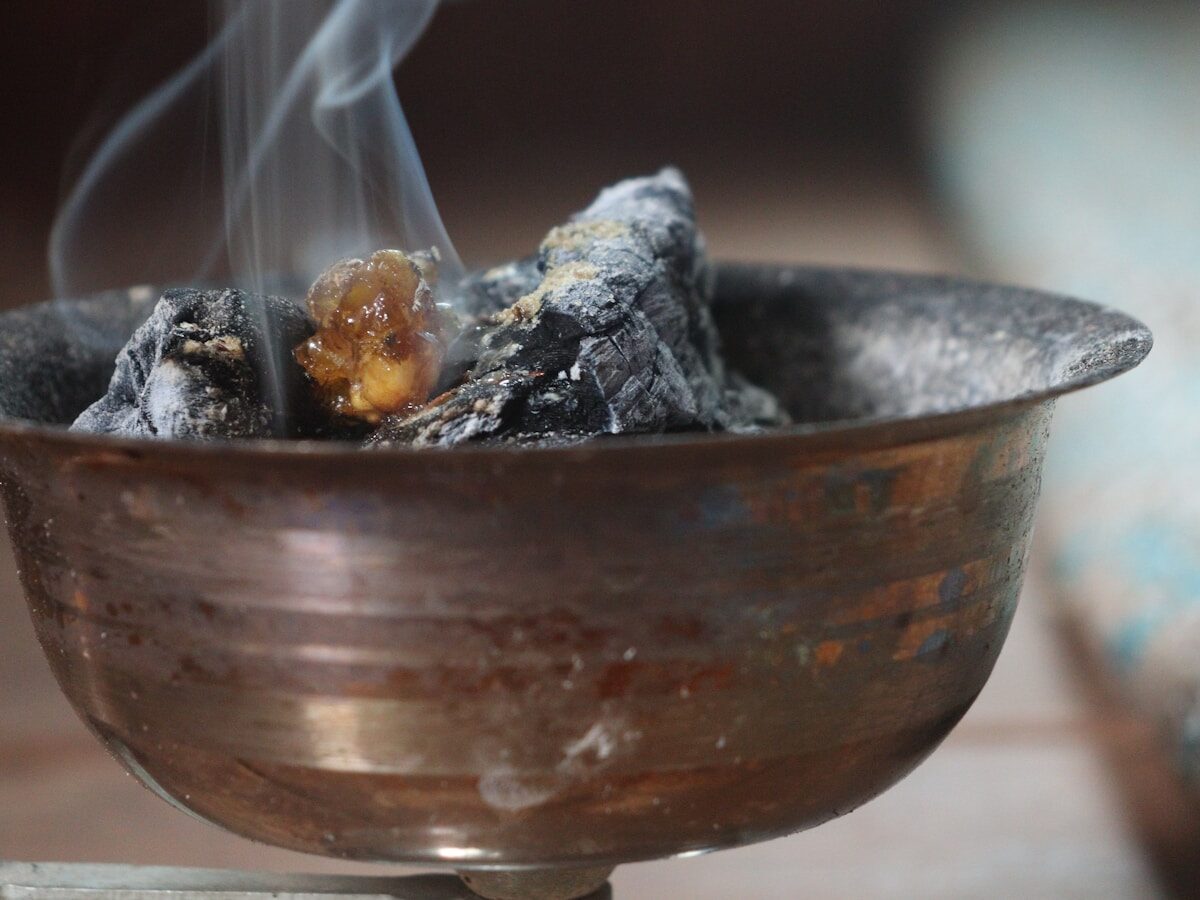 Bakhoor smouldering in a brass burner