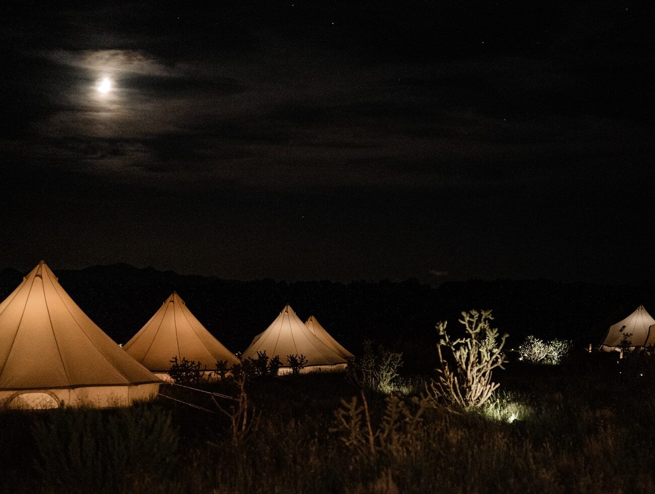 The camp tents under a full moon