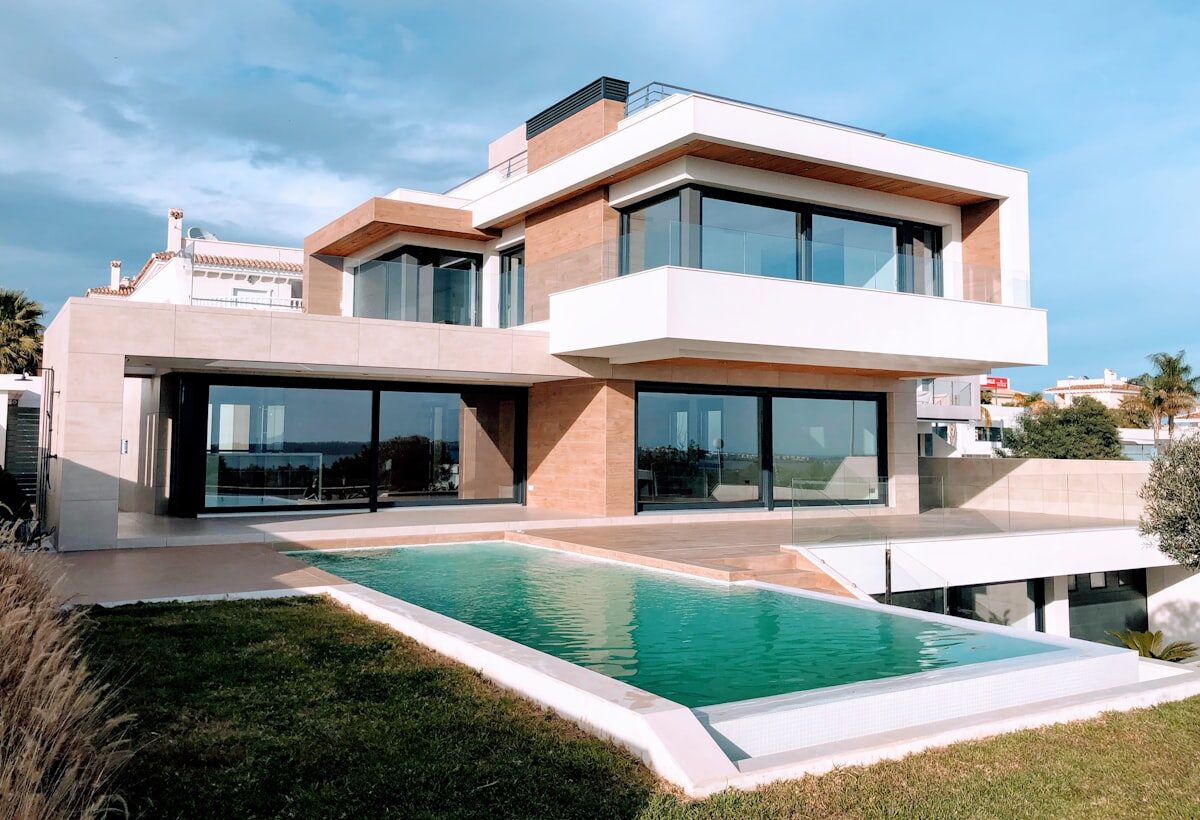 A hillside villa with a pool at dusk